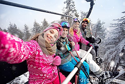 Happy family in cable car climb to ski terrain Stock Photo