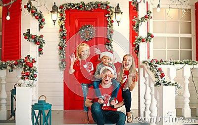 Happy family in Christmas in yard of New Year`s house, tradition celebrating parents with children Stock Photo