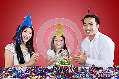 Happy family clapping in a birthday party Stock Photo