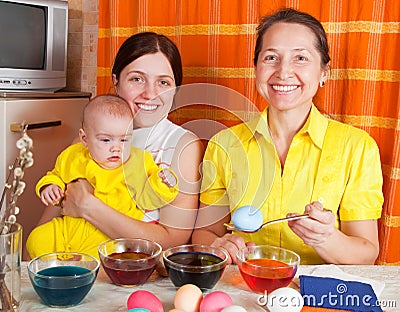 Happy family coloring easter eggs Stock Photo