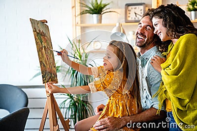 Happy family concept. Young parents with children painting together at home. People fun happyiness. Stock Photo