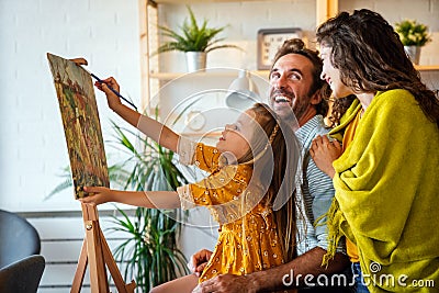 Happy family concept. Young parents with children painting together at home. People fun happyiness. Stock Photo