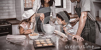 Happy family cooking biscuits together Stock Photo