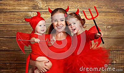 Happy family with costumes devil prepares for Halloween Stock Photo