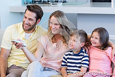 Happy family on the couch watching tv Stock Photo