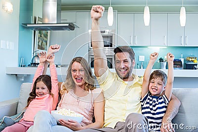 Happy family on the couch watching tv Stock Photo