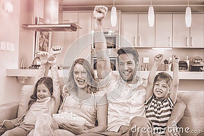 Happy family on the couch watching tv Stock Photo