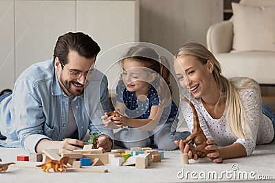 Happy family couple and daughter girl playing with toy blocks Stock Photo