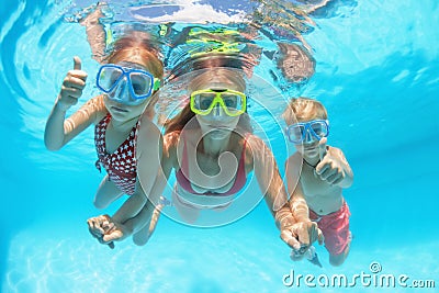 Happy family dive underwater with fun in swimming pool Stock Photo