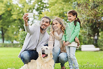 Happy family with dog taking selfie by smartphone Stock Photo