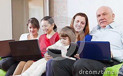 Happy family enjoys on sofa in livingroom Stock Photo