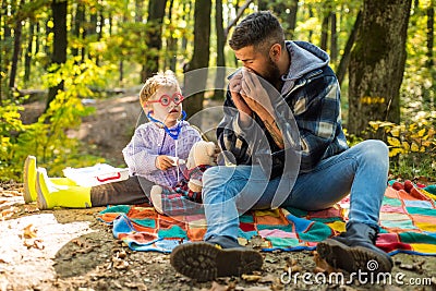 Parent teach baby. Happy family, father and baby son playing and laughing on autumn walk. Father playing with little son Stock Photo