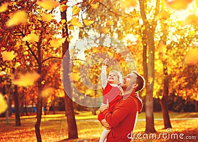 Happy family father and child daughter on a walk in autumn leaf Stock Photo