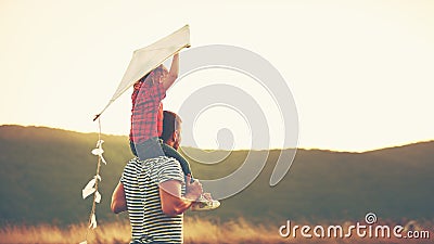 Happy family father and child on meadow with a kite in summer Stock Photo