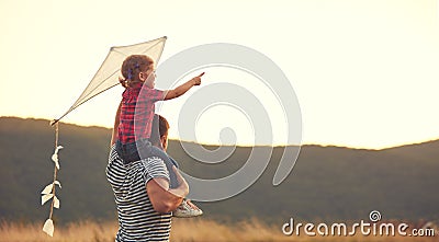 Happy family father and child on meadow with a kite in summer Stock Photo