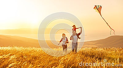 Happy family father of mother and child daughter launch a kite o Stock Photo