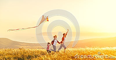 Happy family father of mother and child daughter launch a kite o Stock Photo