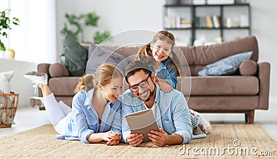 Happy family. father, mother and child with tablet computer at home Stock Photo