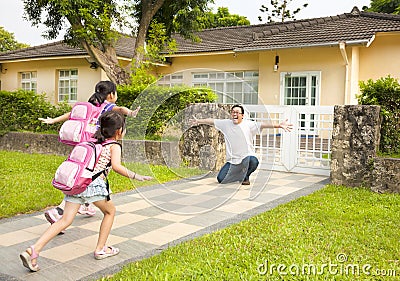 Happy family in front of house Stock Photo