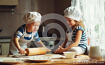 Happy family funny kids bake cookies in kitchen Stock Photo