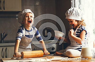 Happy family funny kids bake cookies in kitchen Stock Photo