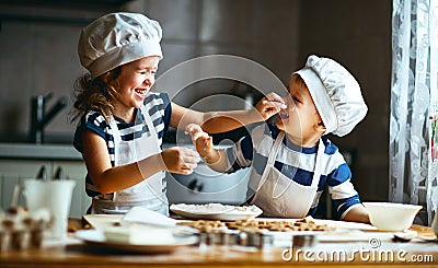 Happy family funny kids bake cookies in kitchen Stock Photo