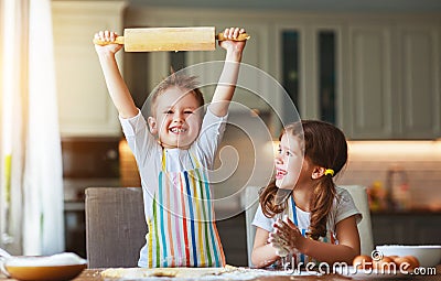 Happy family funny kids bake cookies in kitchen Stock Photo