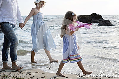 Happy family future parents with hiking near sea Stock Photo