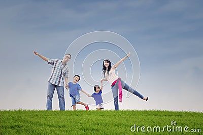 Happy family at green hill Stock Photo