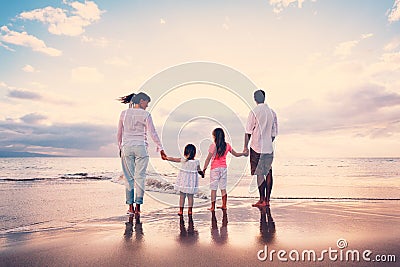 Happy Family have Fun Walking on Beach at Sunset Stock Photo