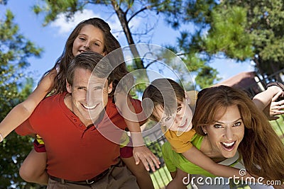 Happy Family Having Fun Outside In Park Stock Photo