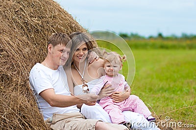 Happy family in haystack or hayrick Stock Photo