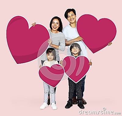 Happy family holding heart shapes Stock Photo