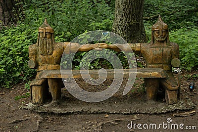 Greenman sculpture setting in forest dappled with sun and shade at Renassiance Festiva Stock Photo