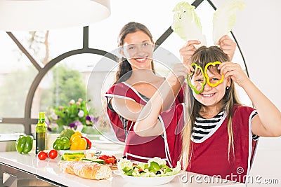 Happy family keeps fresh pieces of bell pepper Stock Photo