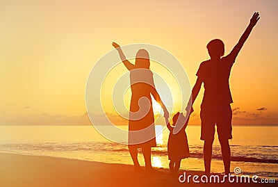 Happy family with kid having fun on sunset beach Stock Photo