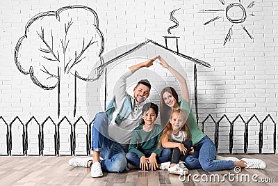 Happy family with kids dreaming about house. Illustrations on brick wall Stock Photo