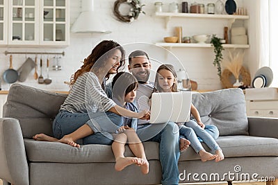 Happy family with kids sit on couch using laptop Stock Photo