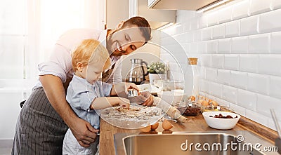 Happy family in kitchen. father and child baking cookies Stock Photo