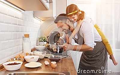 Happy family in kitchen. Father and child daughter knead dough a Stock Photo