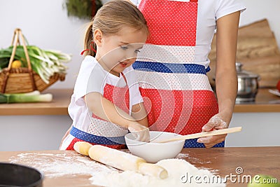 Happy family in the kitchen. Mother and child daughter cooking holiday pie or cookies for Mothers day Stock Photo