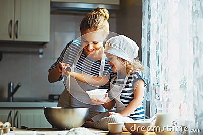 Happy family in kitchen. mother and child preparing dough, bake Stock Photo