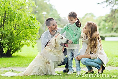 Happy family with labrador retriever dog in park Stock Photo