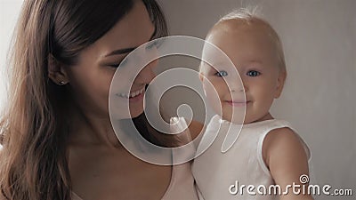 Happy family laughing faces, mother holding adorable child baby boy, smiling and hugging, close up border, beauty of Stock Photo