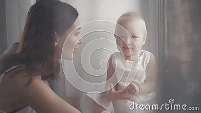 Happy family laughing faces, mother holding adorable child baby boy, smiling and hugging, close up border, beauty of Stock Photo