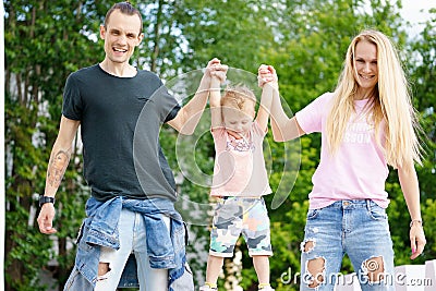 Happy family lift up their son Stock Photo