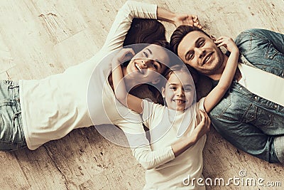 Happy Family Lying of Floor Together at Home Stock Photo