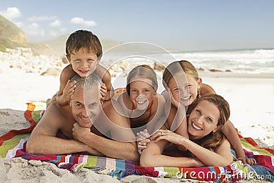 Happy Family Lying Together At Beach Stock Photo