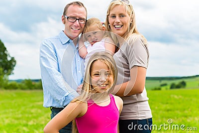 Happy Family in the meadow Stock Photo