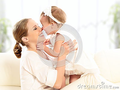 Happy family. Mother and baby daughter plays, hugging, kissing Stock Photo